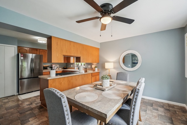 4630 Pasture Ln, White Lake, MI 48383 - dining room with stone tile floors, ceiling fan, and baseboards