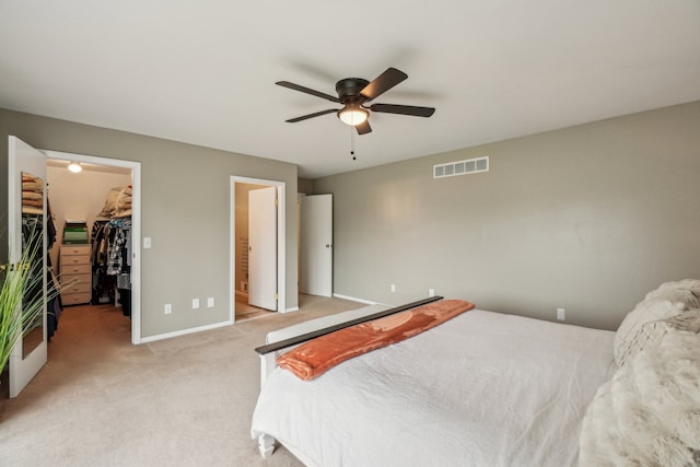 4630 Pasture Ln, White Lake, MI 48383 - bedroom with a walk in closet, light colored carpet, baseboards, a closet, and a ceiling fan