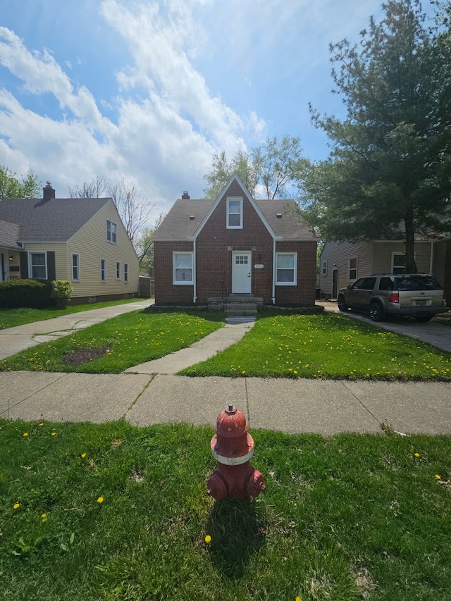 bungalow-style house with a front lawn