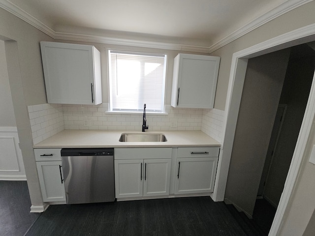 kitchen with stainless steel dishwasher, a sink, decorative backsplash, white cabinets, and ornamental molding