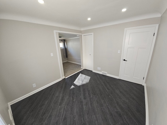 unfurnished bedroom featuring dark wood-type flooring, recessed lighting, and baseboards