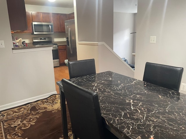 dining area featuring light wood finished floors