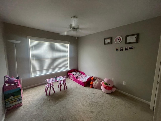 rec room featuring carpet floors, ceiling fan, and baseboards