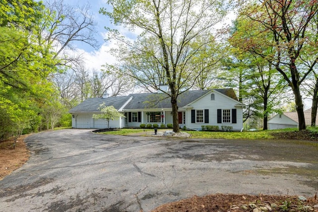 ranch-style home featuring driveway and an attached garage
