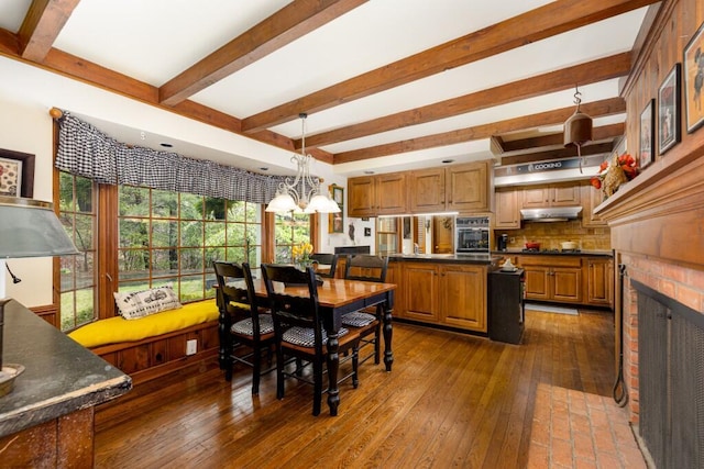 dining area featuring beamed ceiling, dark wood-style floors, and a chandelier