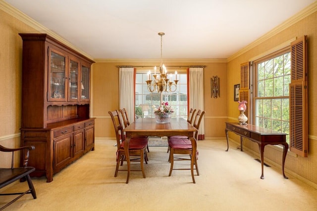 dining space with a chandelier, light carpet, and crown molding