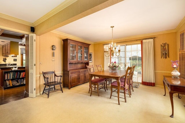 dining room featuring light carpet, a chandelier, crown molding, and baseboards