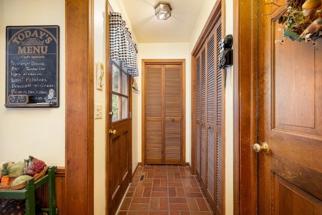 doorway to outside with brick patterned floors