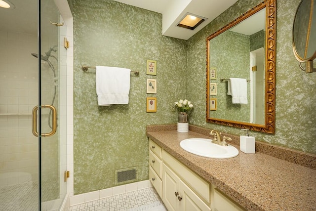 full bath with a stall shower, tile patterned flooring, vanity, and wallpapered walls