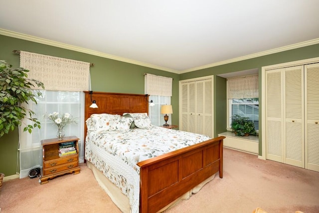bedroom featuring multiple closets, light colored carpet, ornamental molding, and baseboards