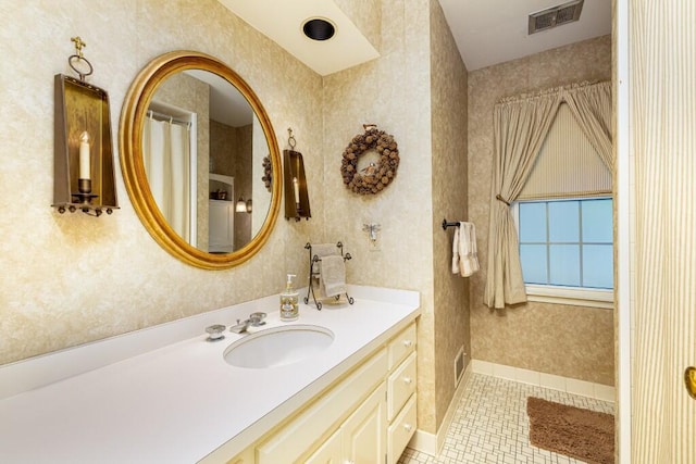 full bath with tile patterned floors, vanity, and wallpapered walls