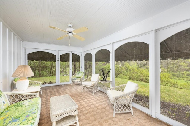 sunroom featuring a ceiling fan