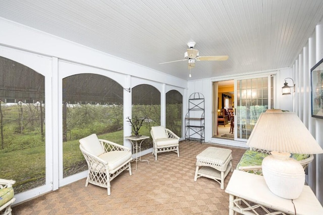sunroom with ceiling fan and carpet floors