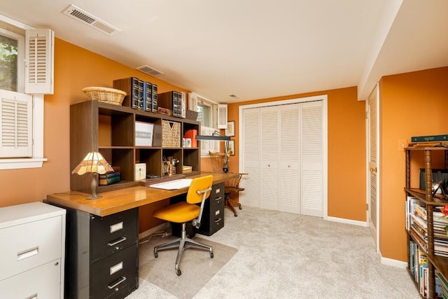 home office featuring light colored carpet and baseboards