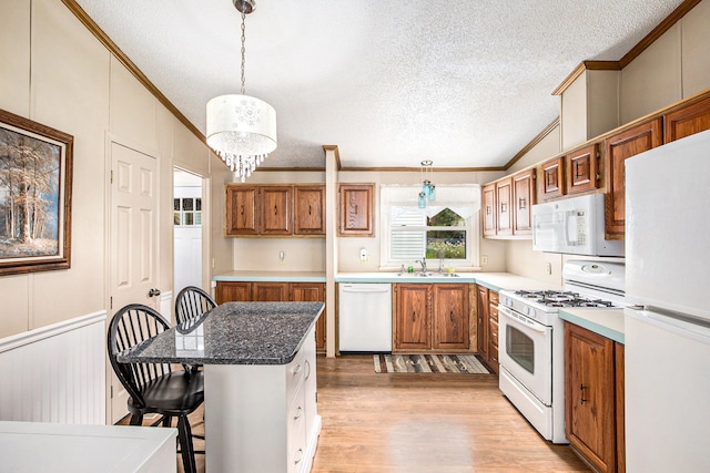 347 Lou Alice Dr, Columbiaville, MI 48421 - kitchen featuring white appliances, crown molding, vaulted ceiling, a textured ceiling, and brown cabinetry