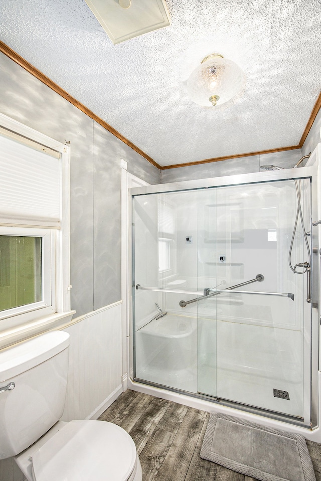 347 Lou Alice Dr, Columbiaville, MI 48421 - full bathroom featuring toilet, wood finished floors, ornamental molding, a stall shower, and a textured ceiling