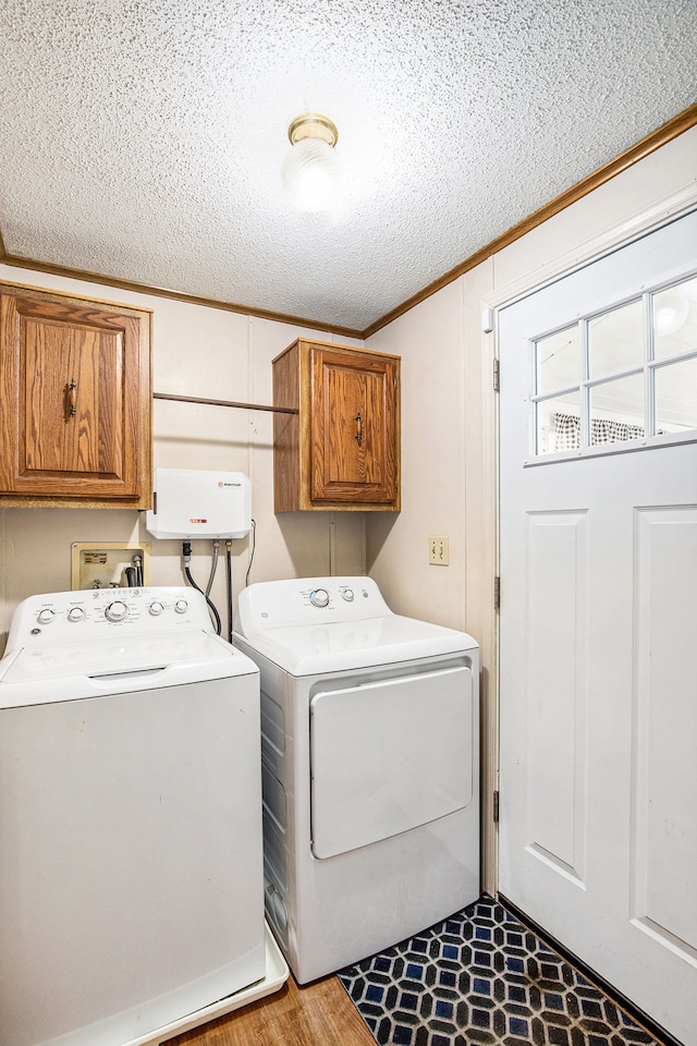 347 Lou Alice Dr, Columbiaville, MI 48421 - clothes washing area with washing machine and dryer, ornamental molding, a textured ceiling, and cabinet space