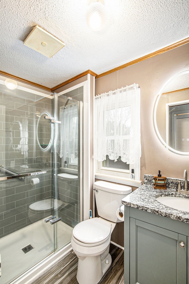 347 Lou Alice Dr, Columbiaville, MI 48421 - full bath featuring ornamental molding, wood finished floors, toilet, a textured ceiling, and vanity