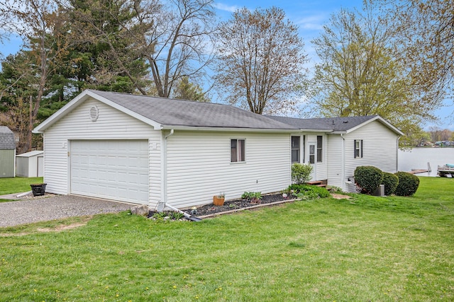 347 Lou Alice Dr, Columbiaville, MI 48421 - view of property exterior with an outdoor structure, a garage, a lawn, driveway, and a shingled roof