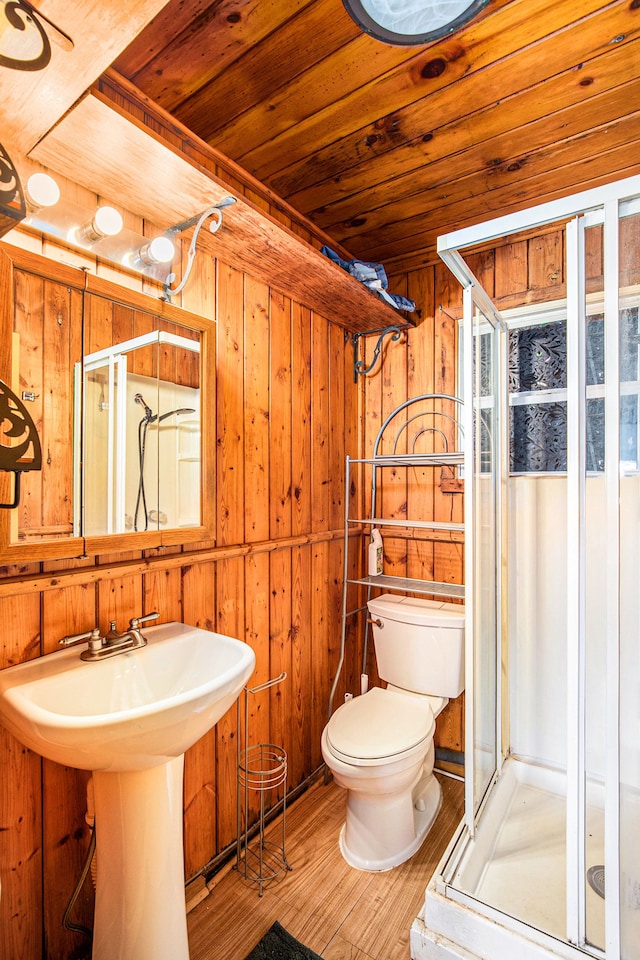 347 Lou Alice Dr, Columbiaville, MI 48421 - bathroom featuring wooden walls, a shower stall, toilet, wood finished floors, and wood ceiling