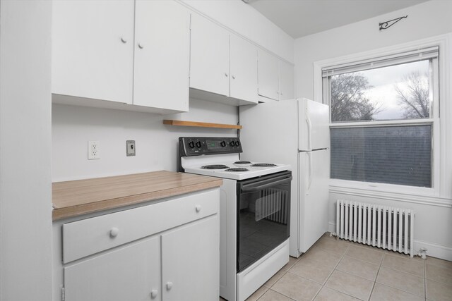 475 Saint Clair St, Grosse Pointe, MI 48230 - kitchen featuring radiator heating unit, white electric stove, white cabinetry, light countertops, and light tile patterned floors