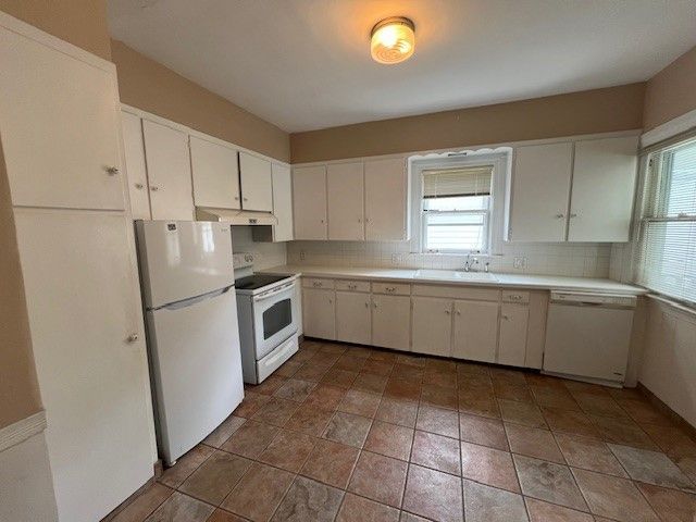 475 Saint Clair St, Grosse Pointe, MI 48230 - kitchen featuring white appliances, light countertops, a sink, and white cabinetry