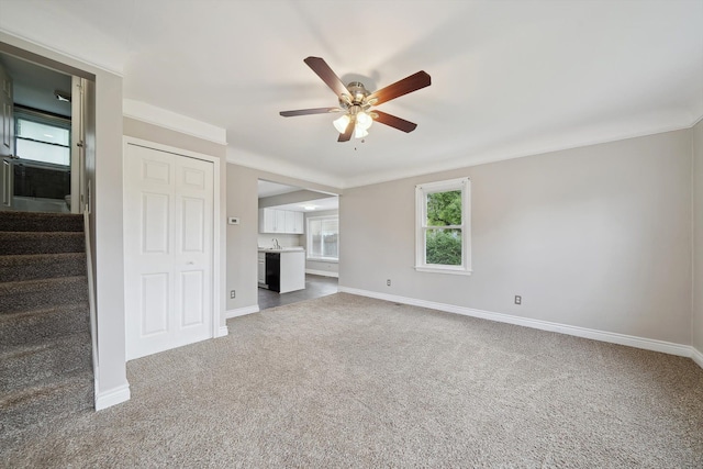 3040 Waukegan St, Auburn Hills, MI 48326 - unfurnished living room with ceiling fan, carpet, baseboards, and stairway
