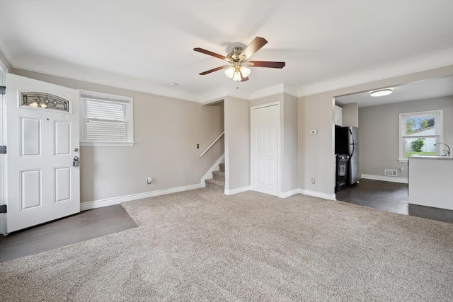 3040 Waukegan St, Auburn Hills, MI 48326 - entryway featuring dark colored carpet, healthy amount of natural light, a ceiling fan, and stairway