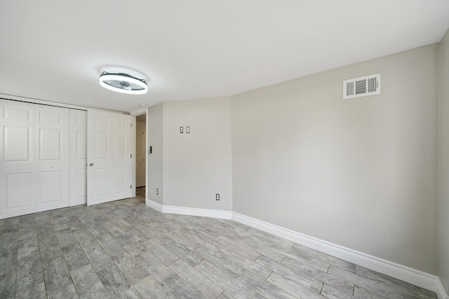 3040 Waukegan St, Auburn Hills, MI 48326 - unfurnished bedroom with light wood-style flooring, baseboards, and a closet