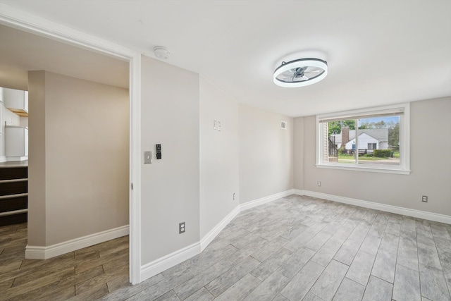 3040 Waukegan St, Auburn Hills, MI 48326 - empty room featuring light wood-type flooring, a smoke detector, and baseboards