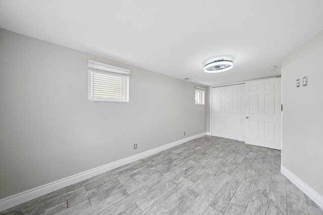 3040 Waukegan St, Auburn Hills, MI 48326 - unfurnished bedroom with light wood-style floors, a closet, multiple windows, and baseboards