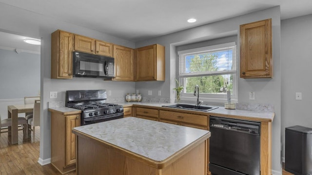 56501 Winding Creek Dr, Macomb, MI 48042 - kitchen with black appliances, a sink, light countertops, wood finished floors, and crown molding