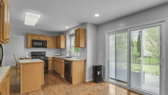 56501 Winding Creek Dr, Macomb, MI 48042 - kitchen with black appliances, a sink, light countertops, plenty of natural light, and recessed lighting