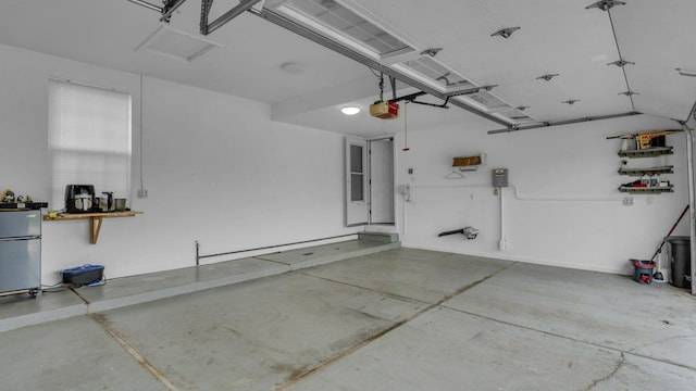 56501 Winding Creek Dr, Macomb, MI 48042 - garage featuring freestanding refrigerator and a garage door opener