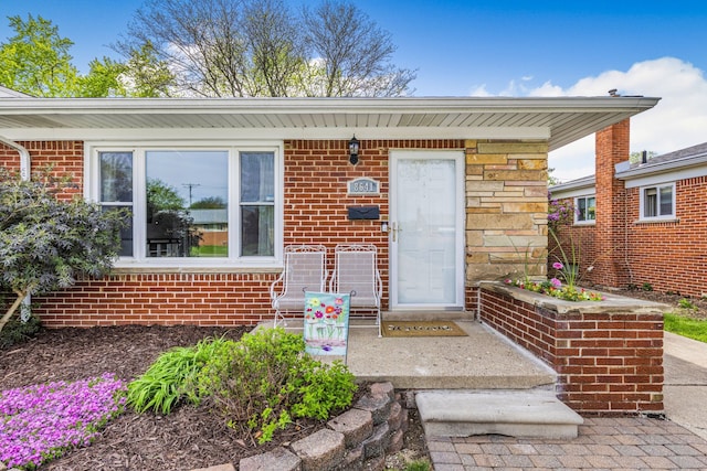 doorway to property with brick siding