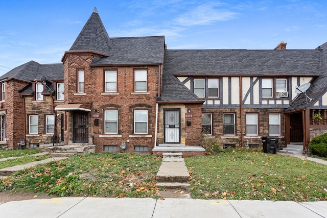 1946 Ewald Cir, Detroit, MI 48238 - view of property featuring a front lawn and roof with shingles
