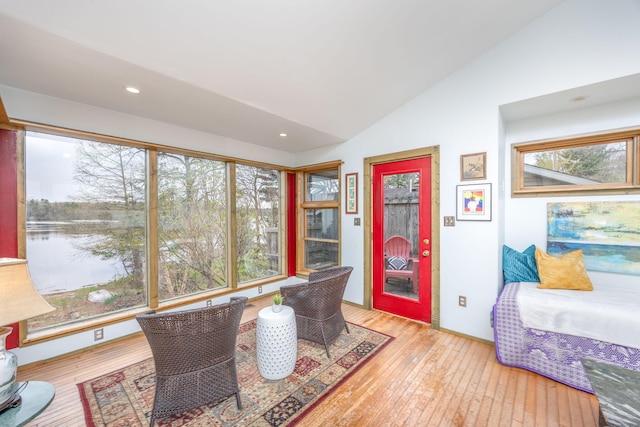 sunroom with vaulted ceiling and healthy amount of natural light
