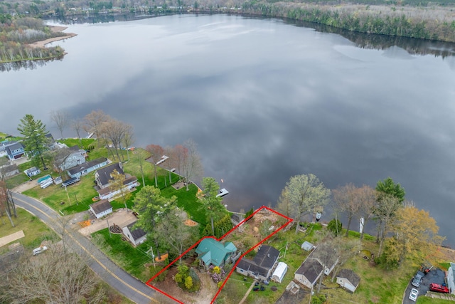 aerial perspective of suburban area featuring a large body of water and property boundaries highlighted