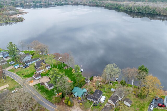 view of property location with a nearby body of water and nearby suburban area