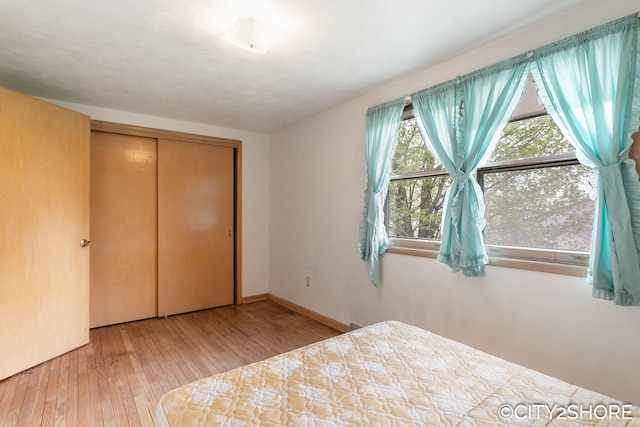 4618 New Holland St, Hudsonville, MI 49426 - unfurnished bedroom with hardwood / wood-style flooring, a closet, and baseboards