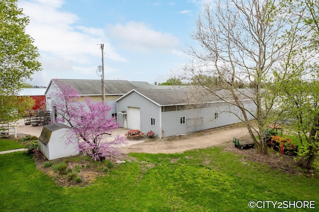 4618 New Holland St, Hudsonville, MI 49426 - rear view of property with a shingled roof, a yard, an outdoor structure, and driveway