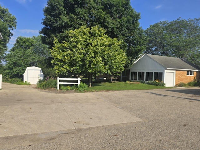 4618 New Holland St, Hudsonville, MI 49426 - view of front of home with an attached garage, a storage shed, and brick siding