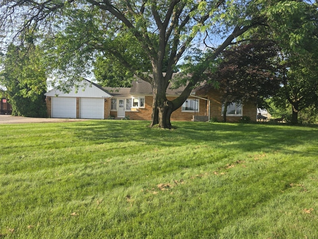 4618 New Holland St, Hudsonville, MI 49426 - ranch-style home featuring driveway, an attached garage, a front yard, and brick siding