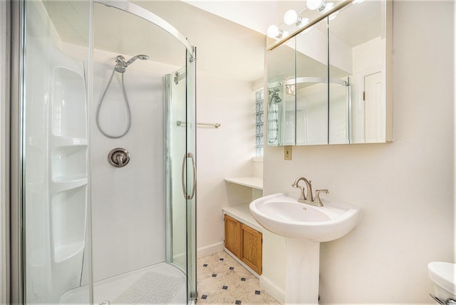 full bath featuring a stall shower and baseboards