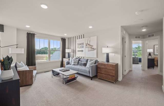 living room with light colored carpet, healthy amount of natural light, recessed lighting, and baseboards