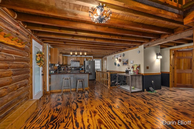 5359 Huck Dr, Sheridan, MI 48884 - bar featuring appliances with stainless steel finishes, beamed ceiling, wainscoting, dark wood finished floors, and rustic walls