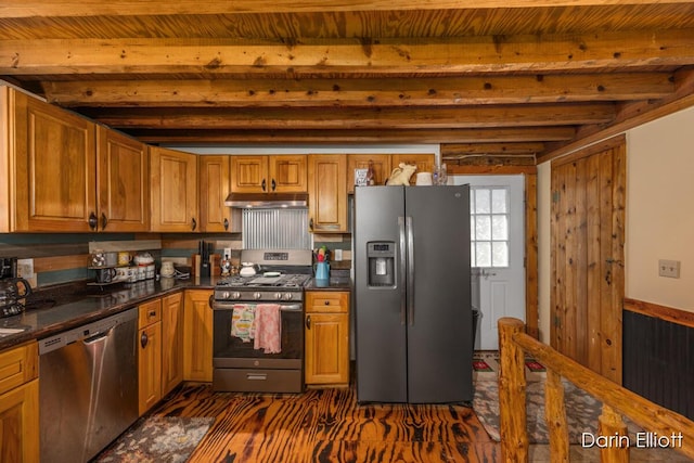 5359 Huck Dr, Sheridan, MI 48884 - kitchen with appliances with stainless steel finishes, under cabinet range hood, beamed ceiling, dark countertops, and brown cabinets