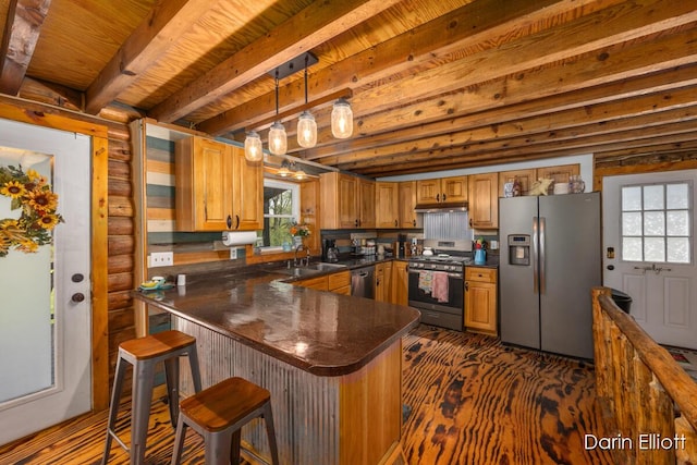 5359 Huck Dr, Sheridan, MI 48884 - kitchen with appliances with stainless steel finishes, dark countertops, a sink, a peninsula, and log walls