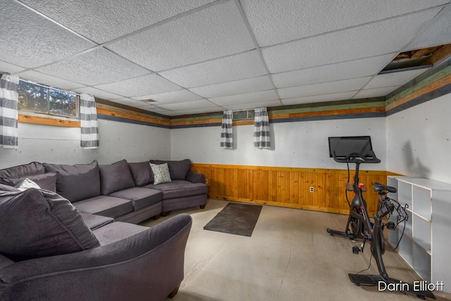 5359 Huck Dr, Sheridan, MI 48884 - living area with concrete floors, wainscoting, a drop ceiling, and wood walls