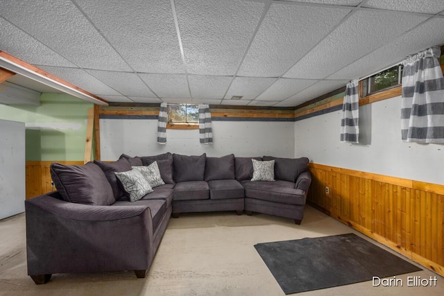 5359 Huck Dr, Sheridan, MI 48884 - living area with wainscoting, wood walls, and a drop ceiling